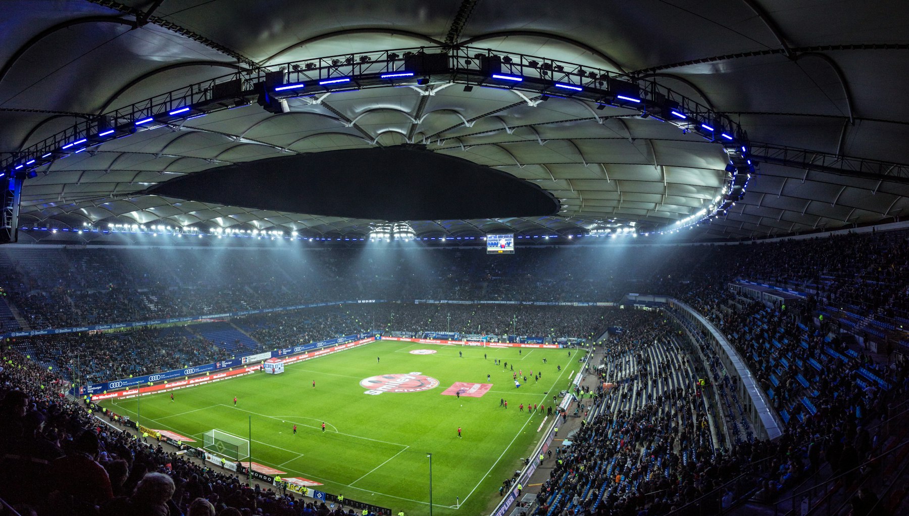 Floodlit football stadium packed with fans, streaming live in 4K on Lemo TV