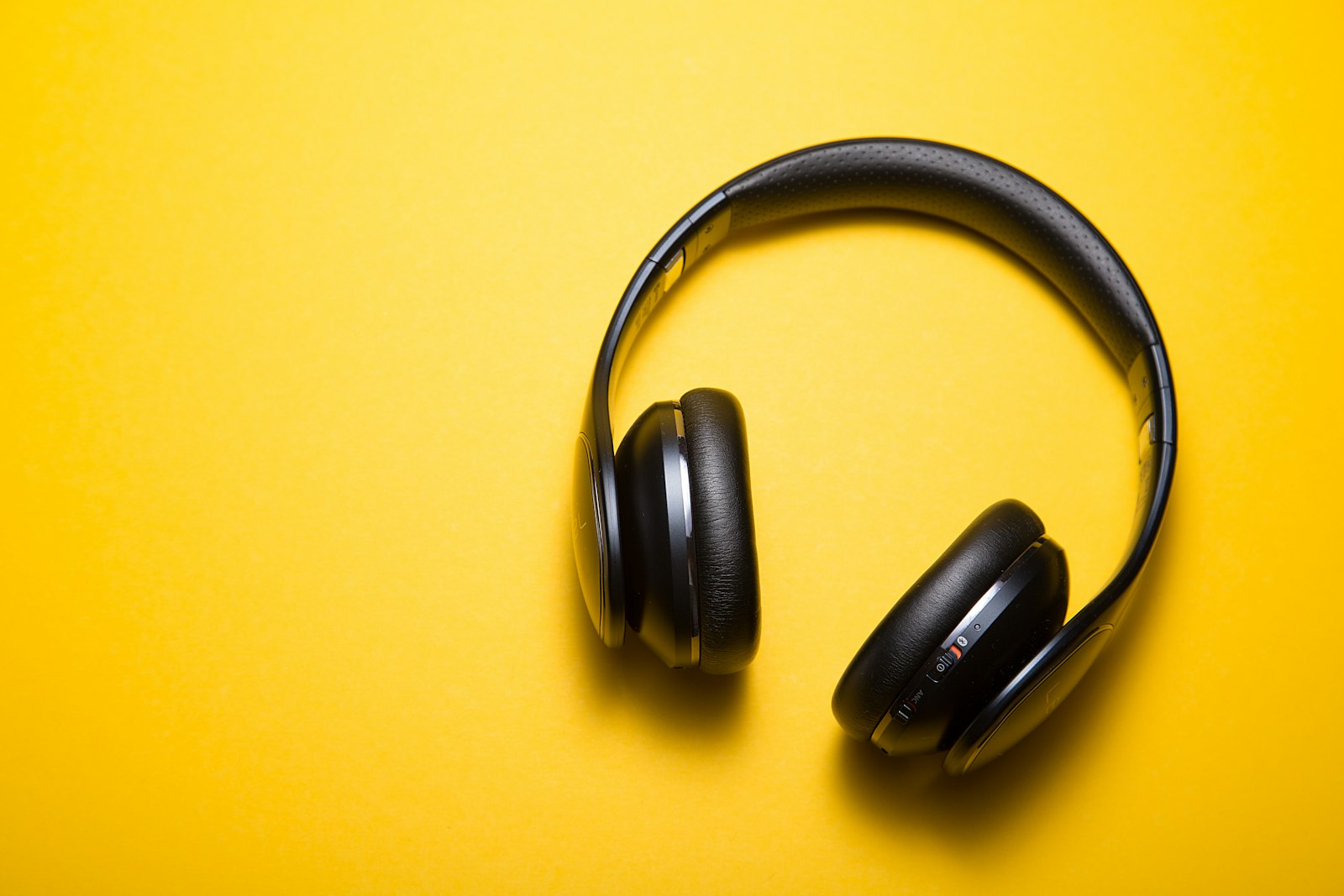 Headphones on a bold background — 24/7 partner support